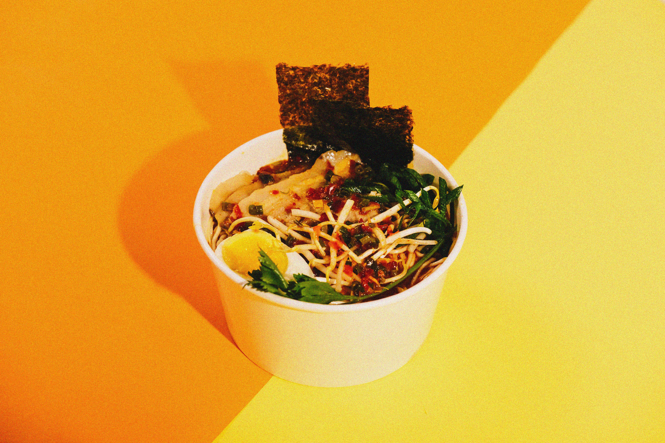 Ramen in a Paper Cup on Orange Background
